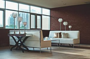 There is a pair of sofas and a coffee table by the window